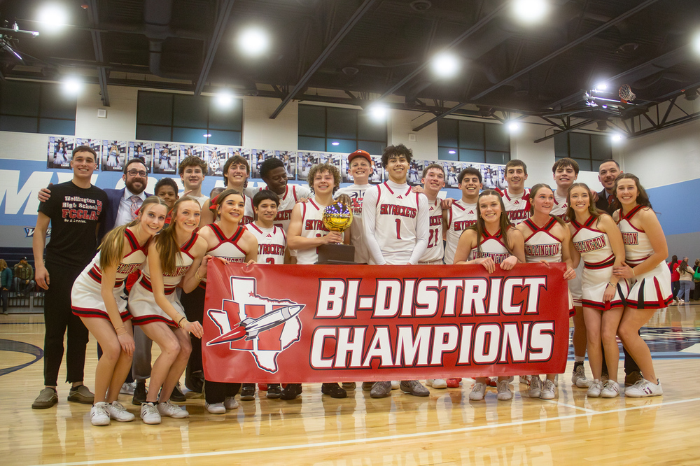 whs boys basketball team poses with cheerleaders and bi-district champions sign