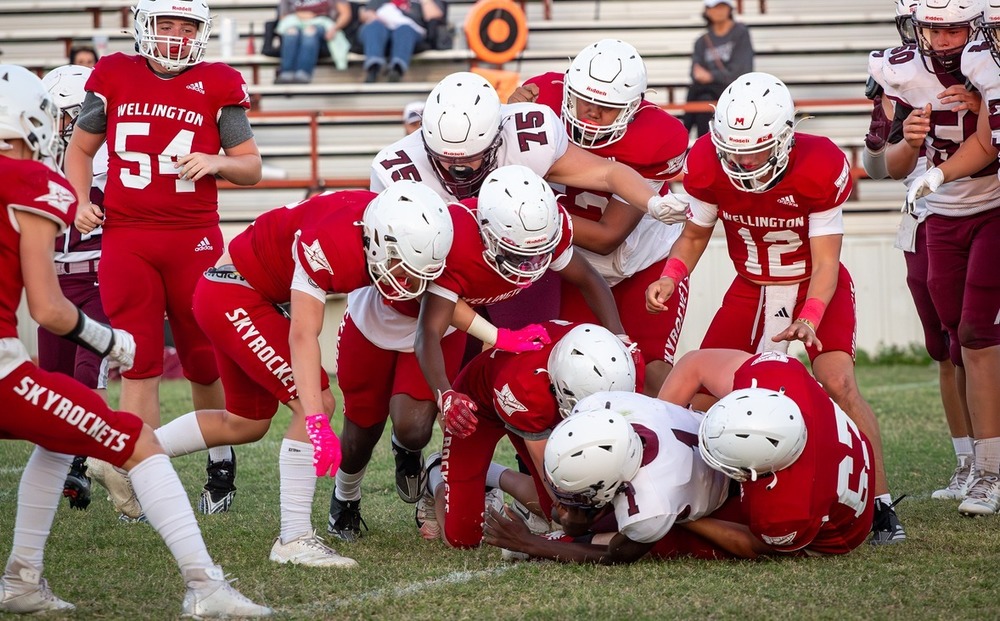 A group of Skyrockets tackle a Clarendon player 