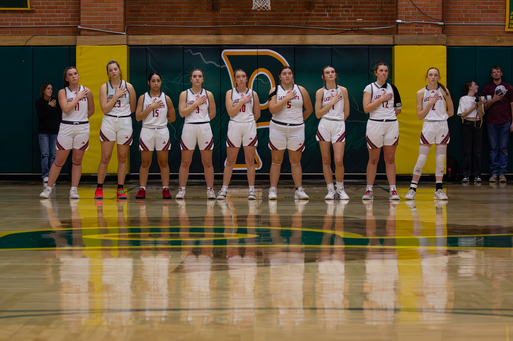 whs girls basketball stands for the national anthem