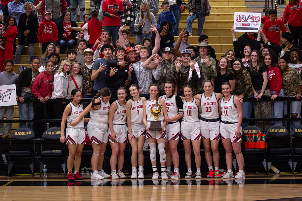 Lady Skyrockets pose with the gold ball and student section
