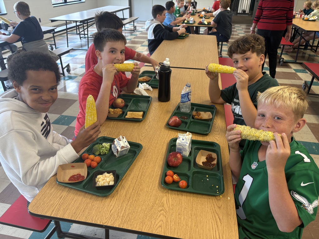 Students eating corn