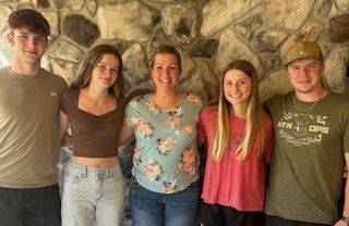 Family in front of stone wall