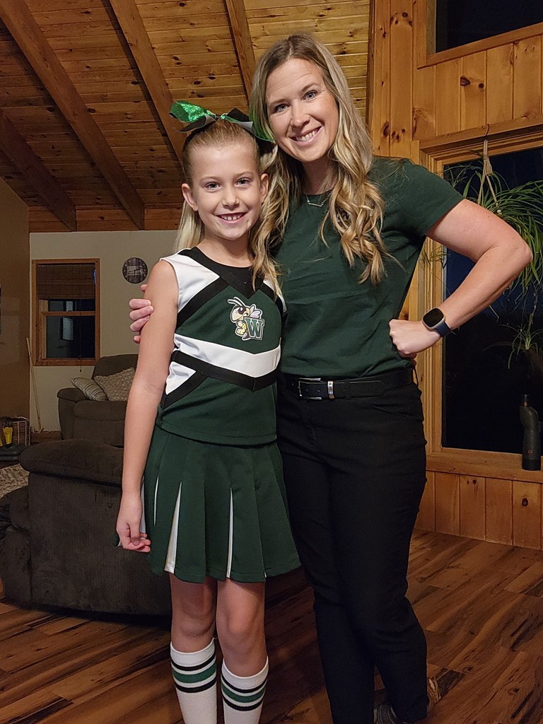 Mother with cheerleader in living room
