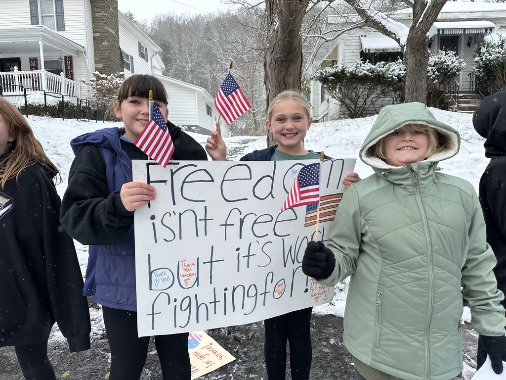 Students holding Veterans Day Sign