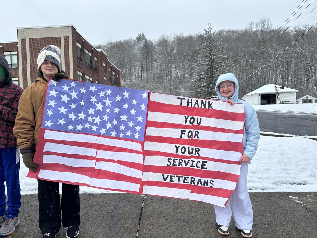 Students holding Veterans Day Sign