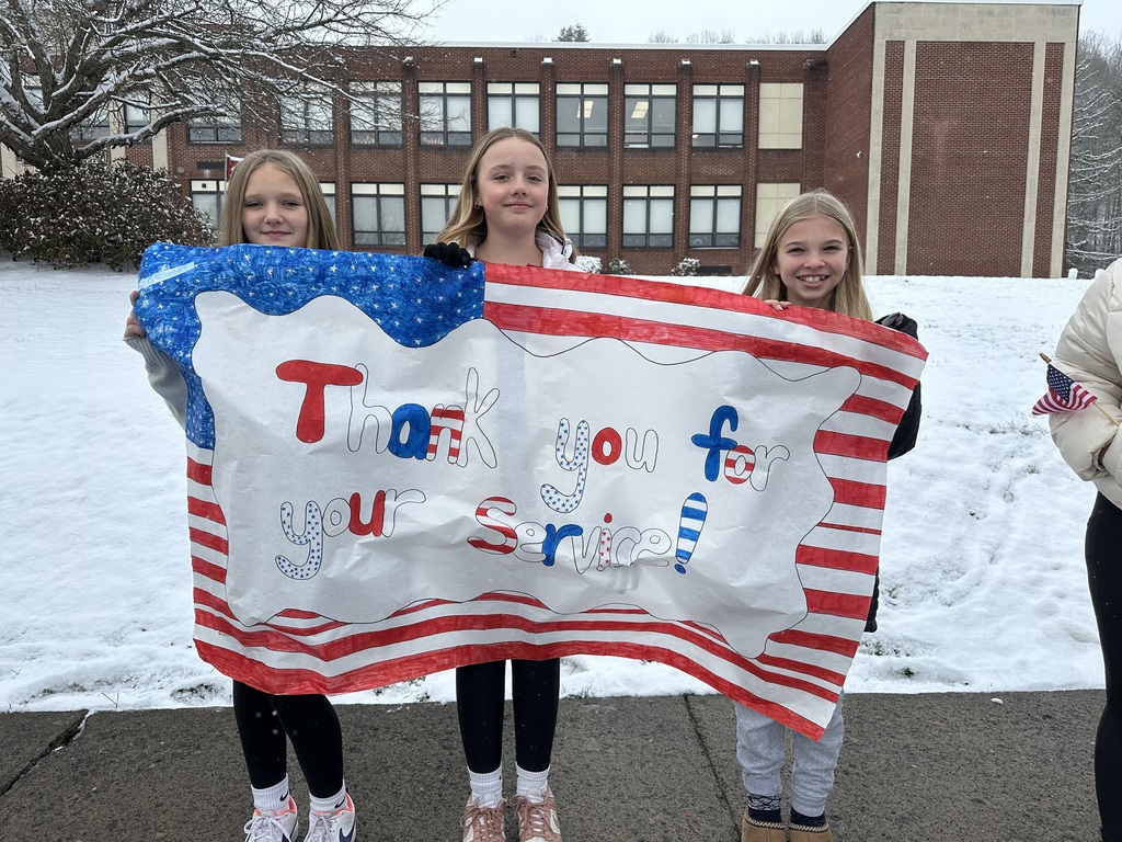 Students holding Veterans Day Sign