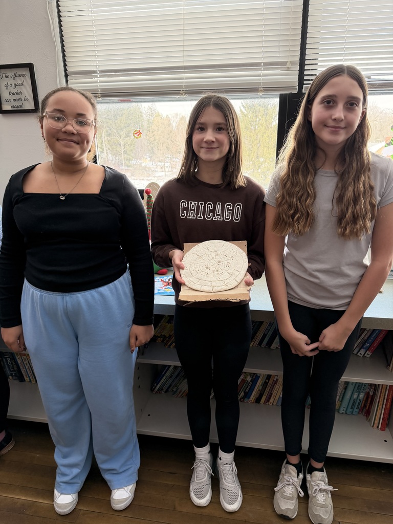 Students holding maya calendar