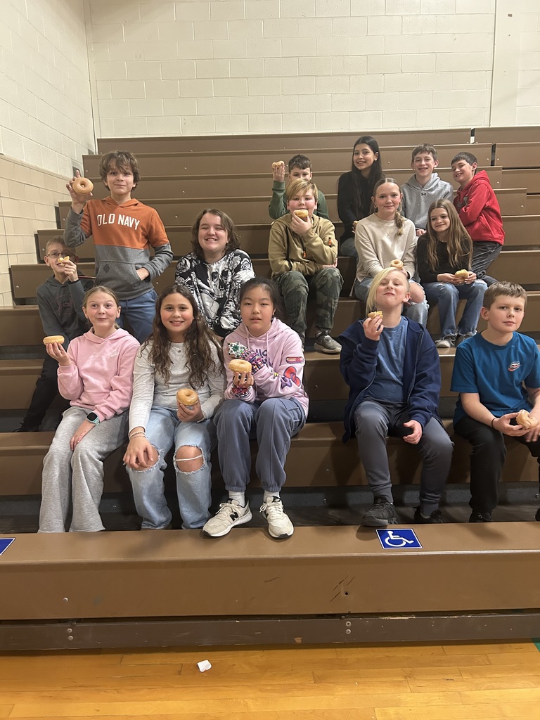 Students in bleachers with donuts