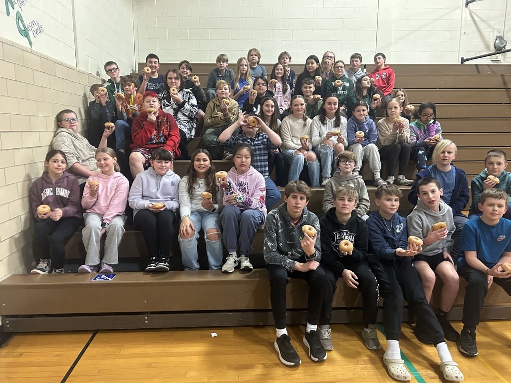 Students in bleachers with donuts