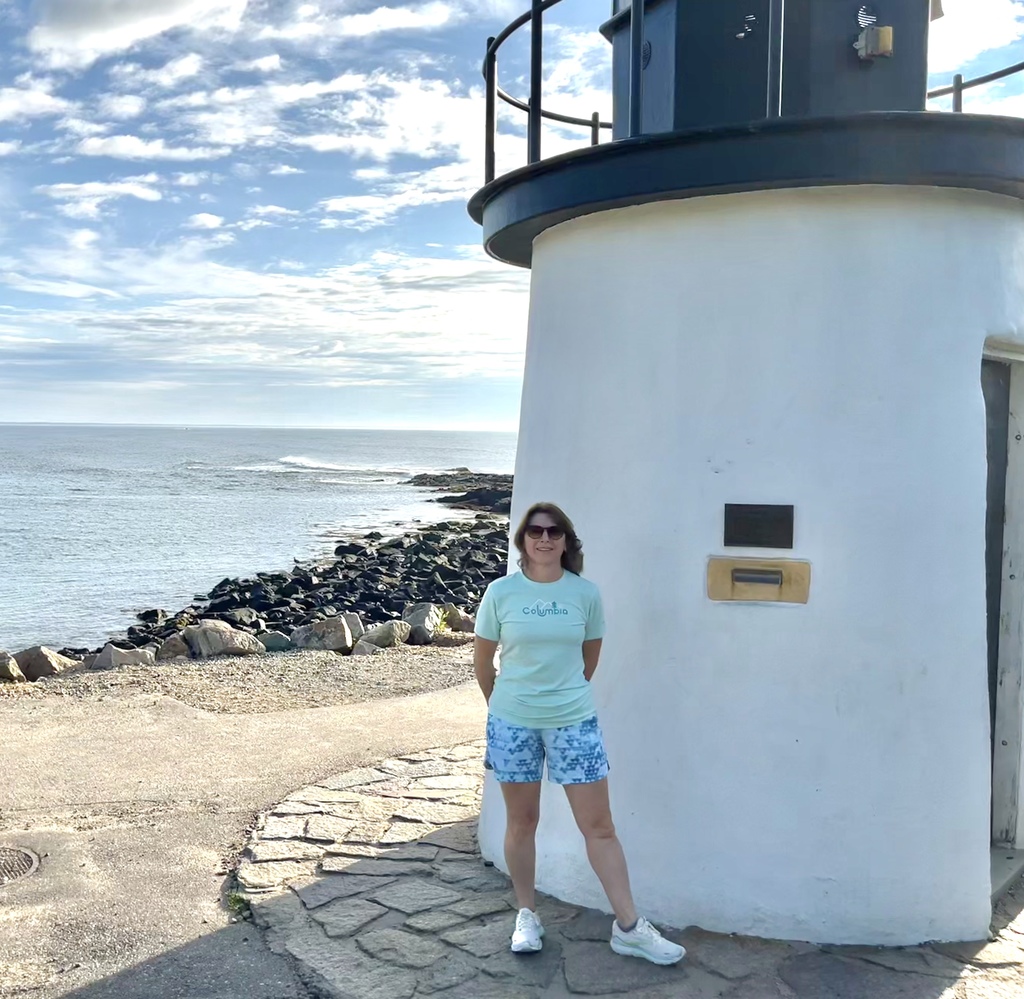 woman in front of lighthouse