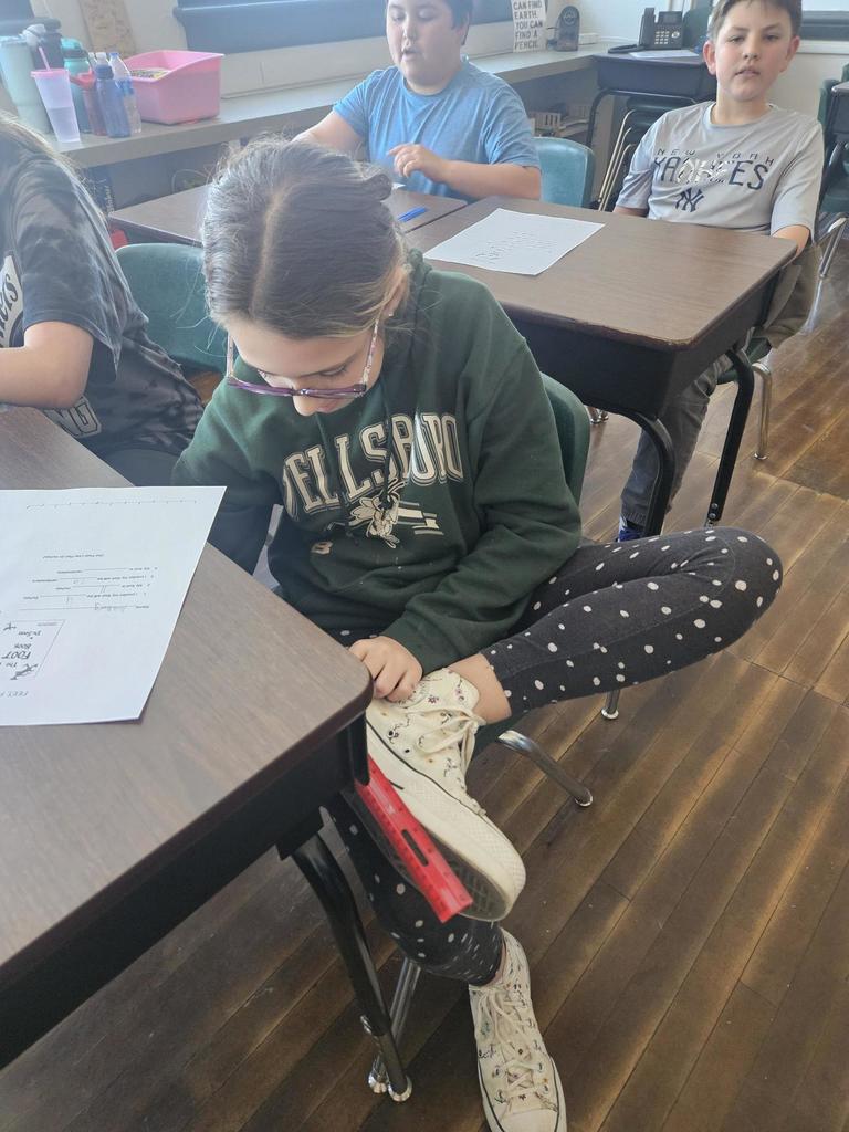 student measuring foot