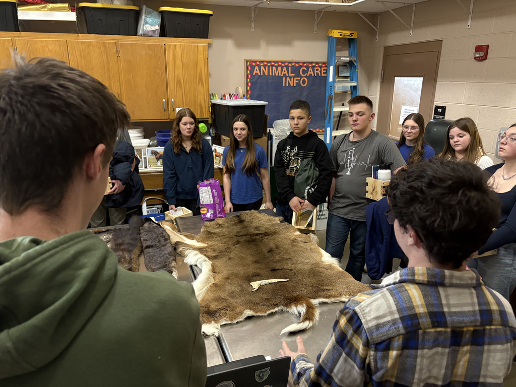 students with deer pelt