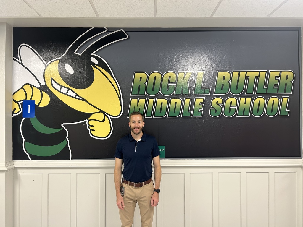 principal in front of wall