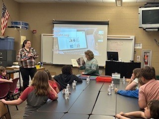 Students listen to a bat read aloud.