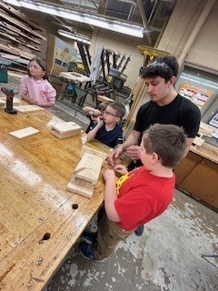 HS student helps elementary students.