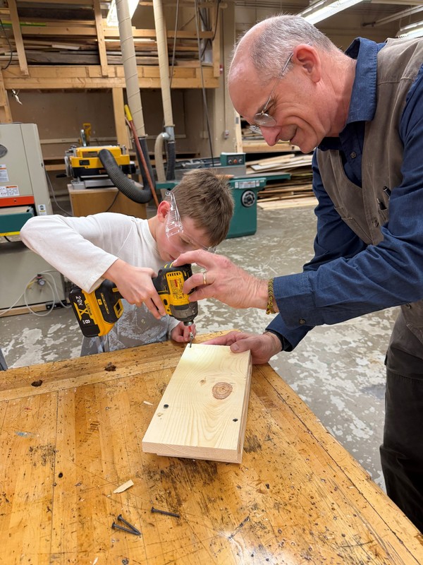 Mr. Reifer helps a student assemble a bat box.