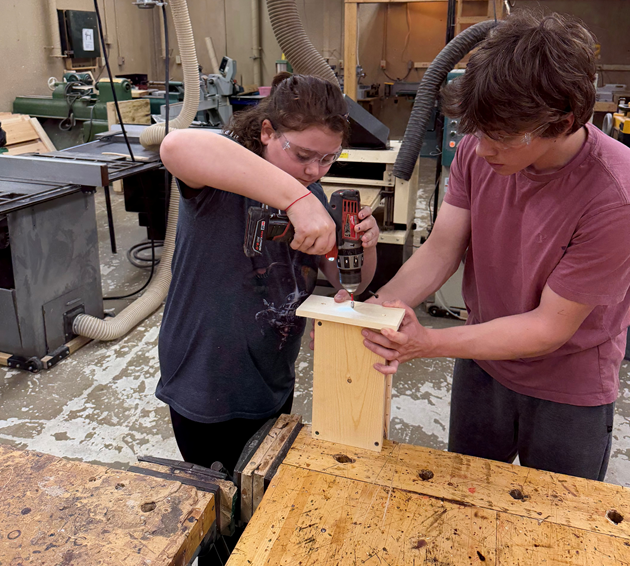 CTE HS student helps younger student.