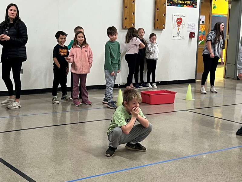 Student watches a ball during bocce lesson.