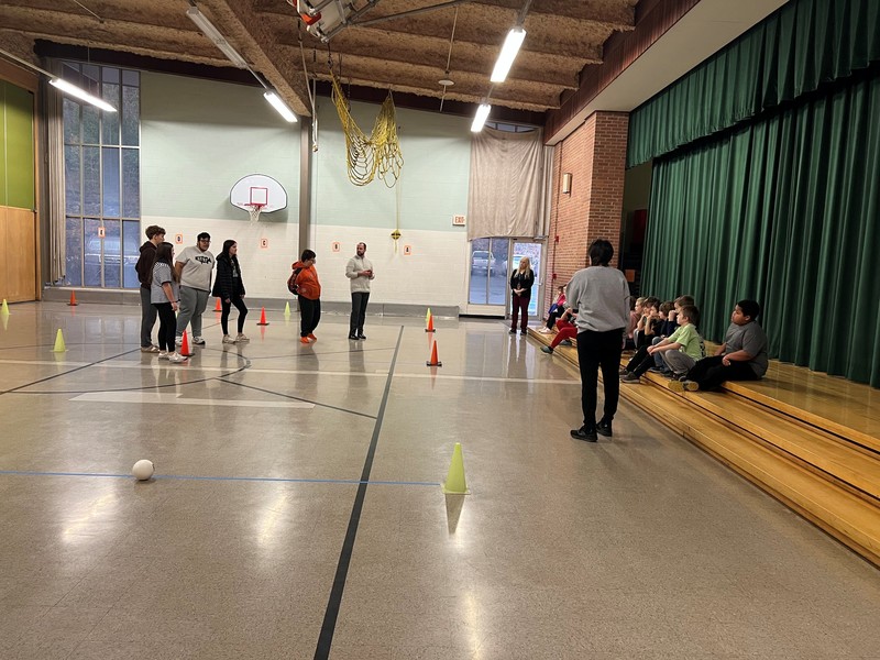 Students in 3rd grade participate in a bocce lesson.