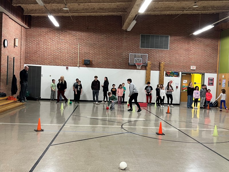 Don Gill 3rd grade students participate in a bocce lesson with HS team.
