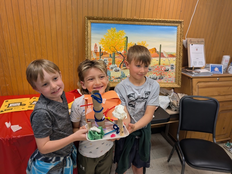 Students holding their artistic creation.