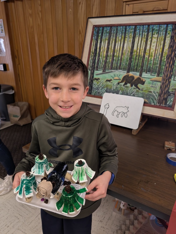 Student holding their artwork.