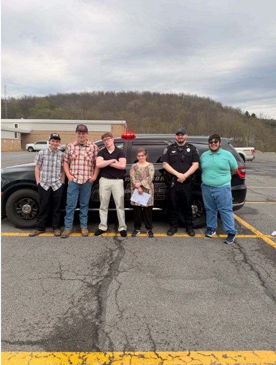 Students pictured with police car on Government Day.