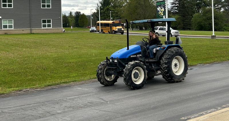 Heidi driving her tractor to school