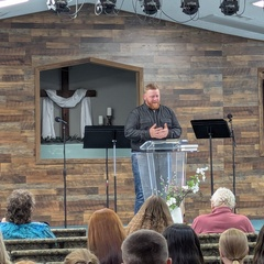 Man preaching with audience in pews