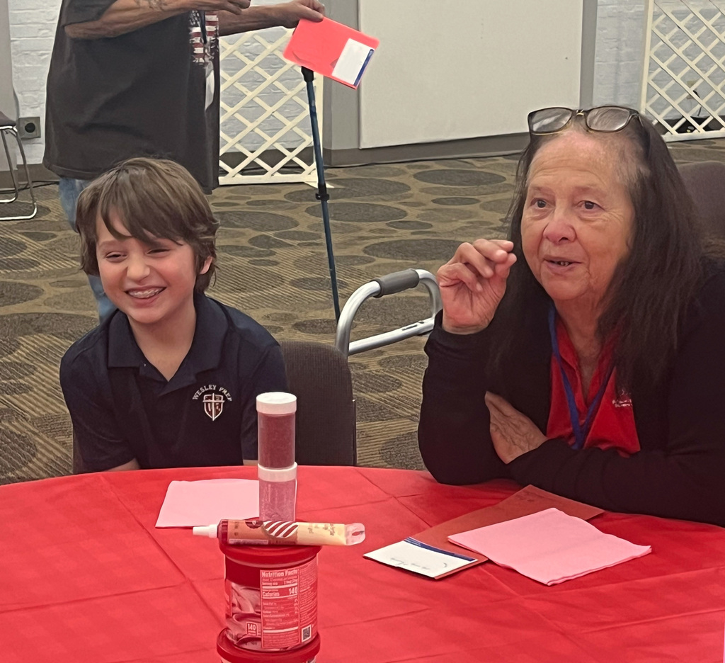 4th grade student laughs with a Wesley-Rankin visitor.