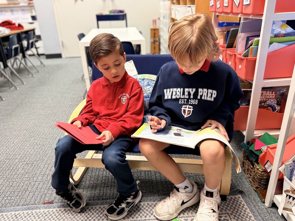 PreK 4 and 1st grade students reading together.