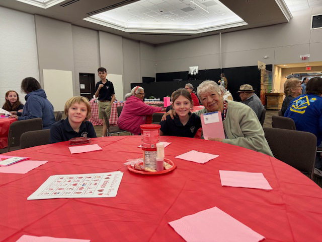 4th grade students smile with a Wesley-Rankin visitor.
