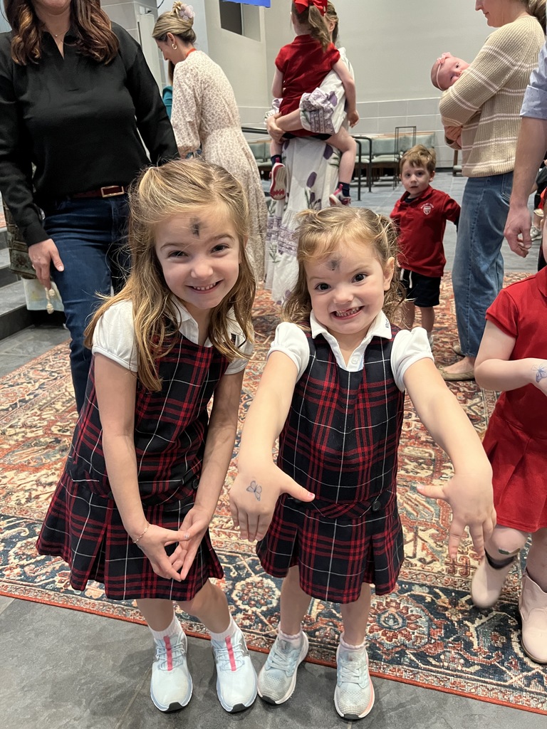 Pre K students smile after receiving their ashes and stamps.