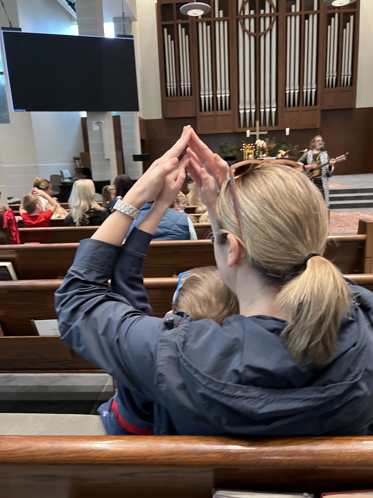 A parent and student rejoice in song.