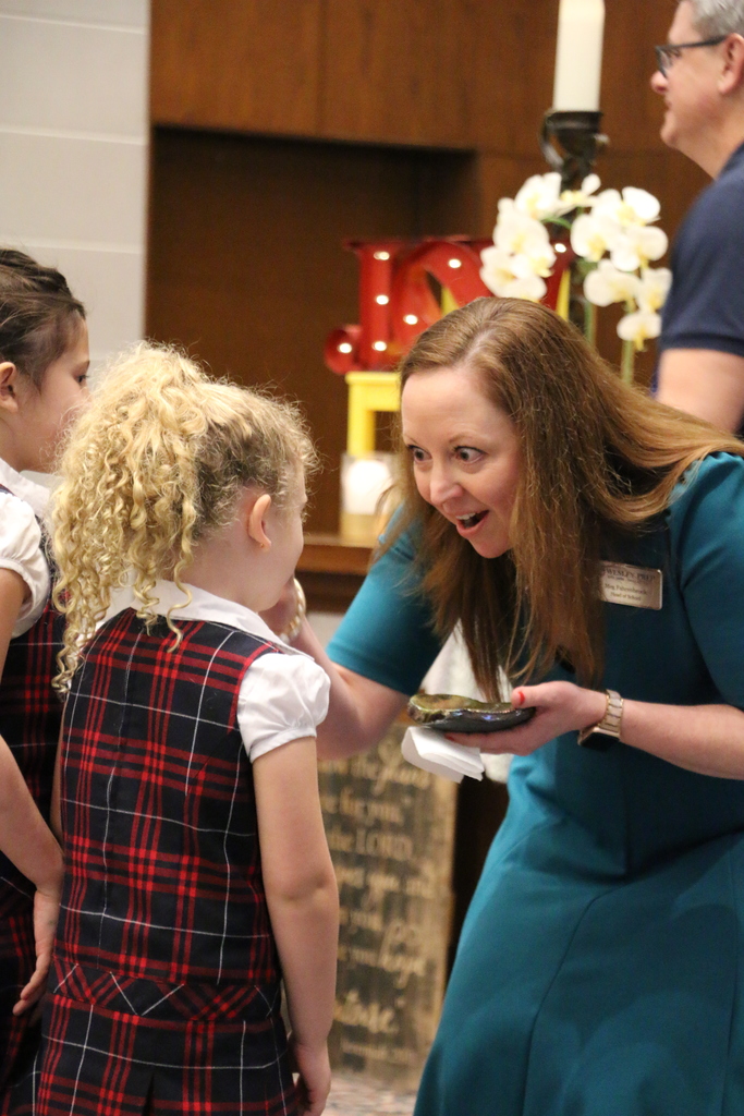 Meg Fahrenbrook rubs ashes on a student's forehead.