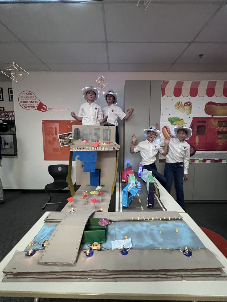 Fourth graders pose with their Texas themed electricity project.