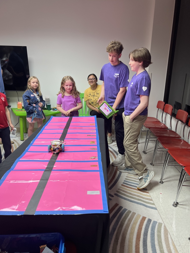 6th graders taking students through their robotics games.