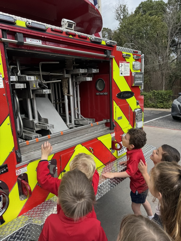 Students examine the inside of a fire truck.