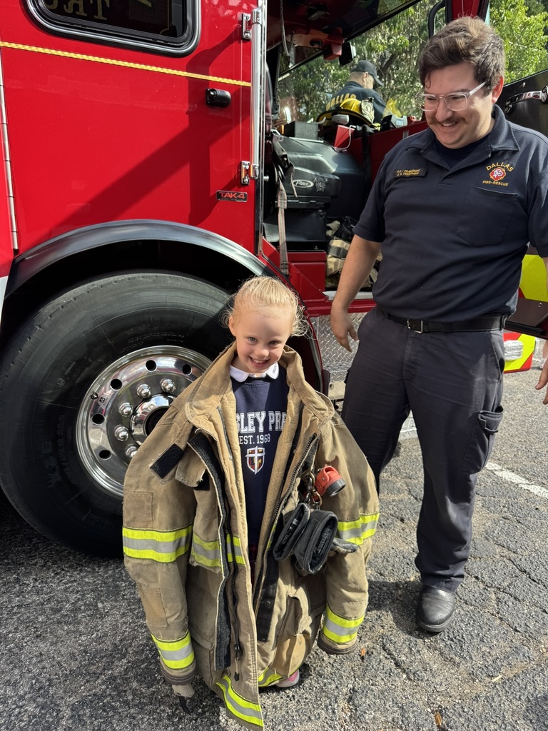 A WP student tries on a Fireman's jacket.