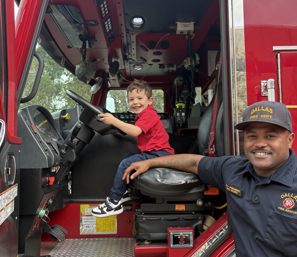 A WP student "drives" the firetruck.