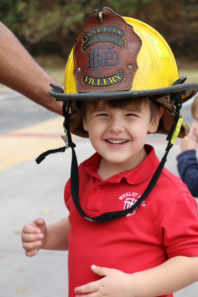 A WP student tries on a Fireman's helmet.