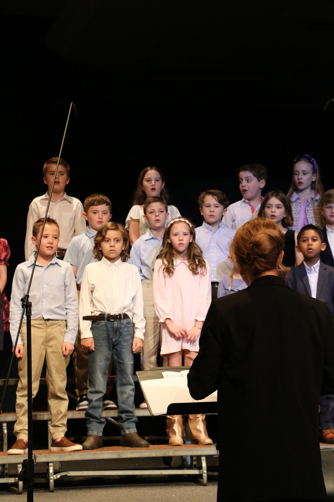 Second grade students sing.