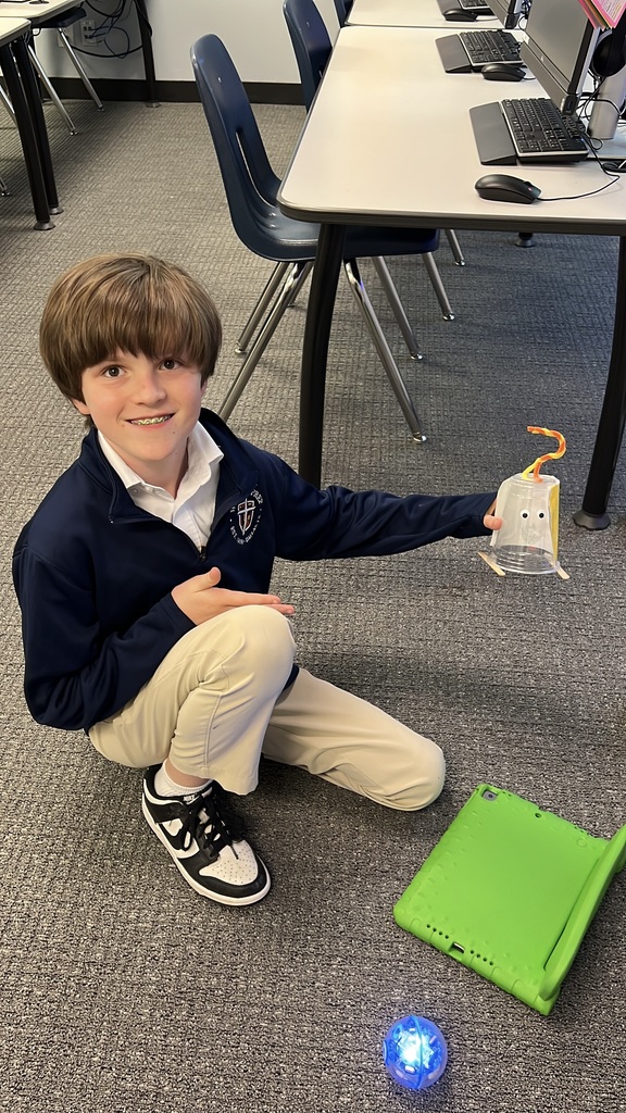 A student poses with parts of his project.