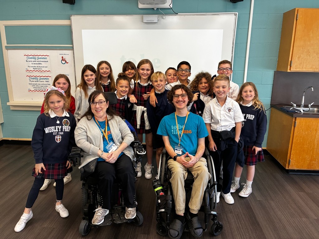 Third graders smiling with representatives of To Be Like Me.