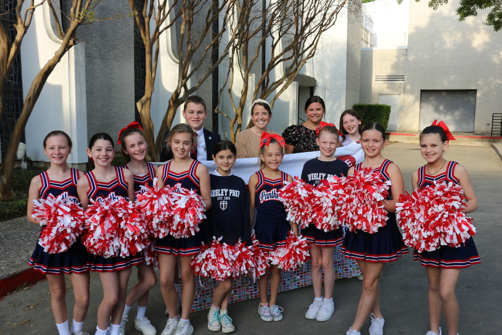 Cheerleaders pose with the Junior Grand Marshals and the First Grade teachers.