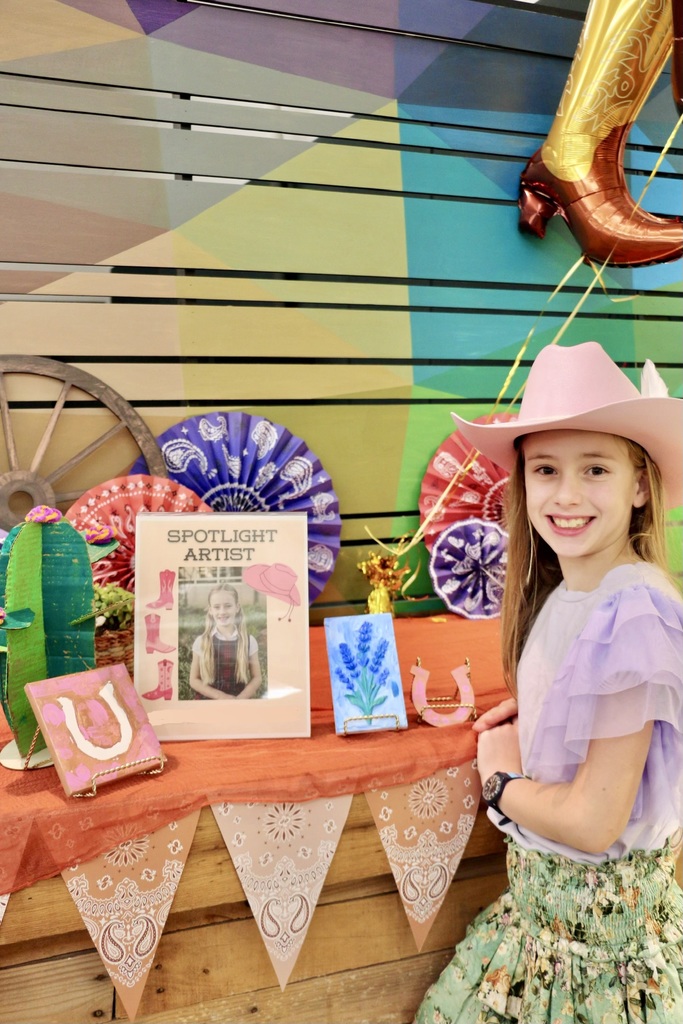 Our spotlight artist with her artwork.
