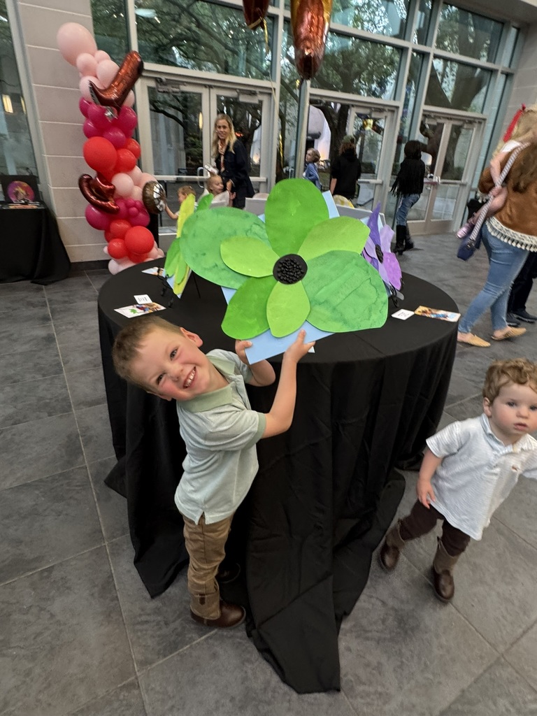 Early childhood student showing his flower art.