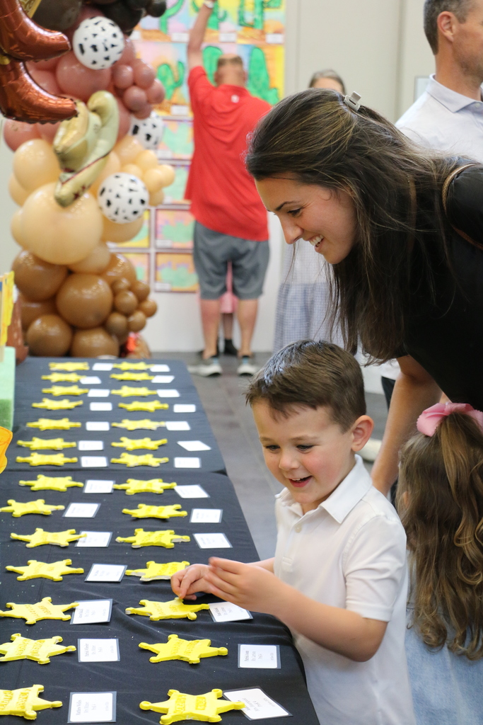 An Early Childhood student trying to show his mom his art.