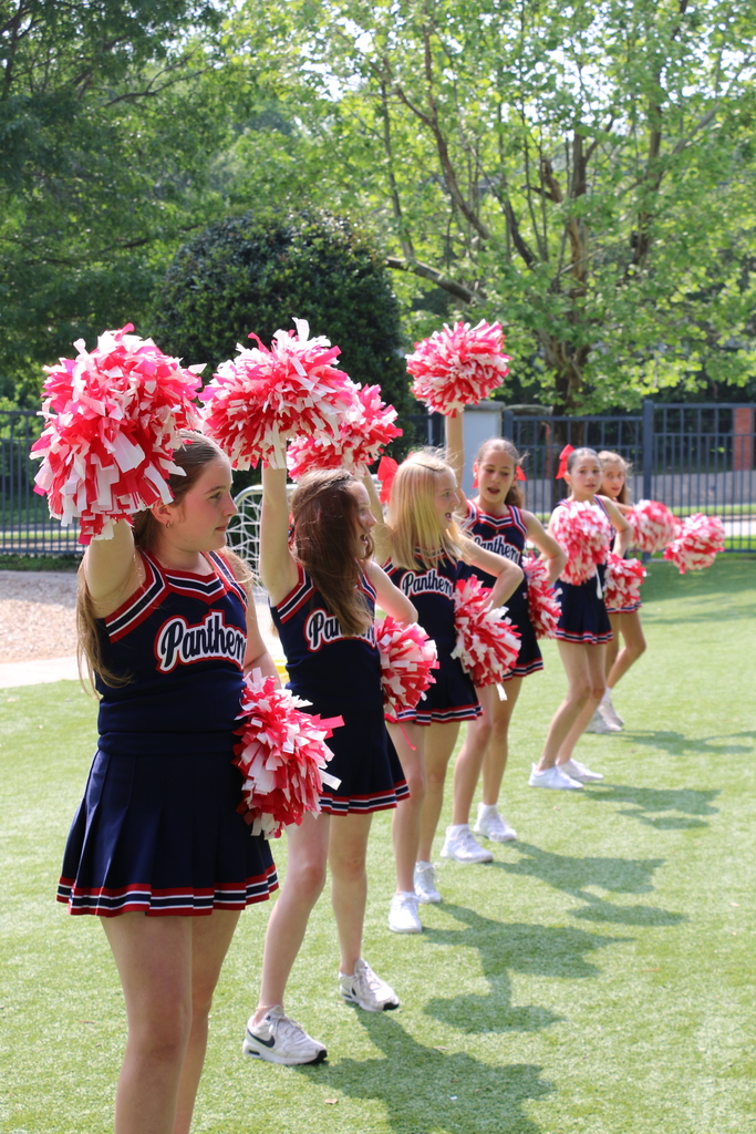 Cheerleaders showcasing the spirit on Inwood Green.