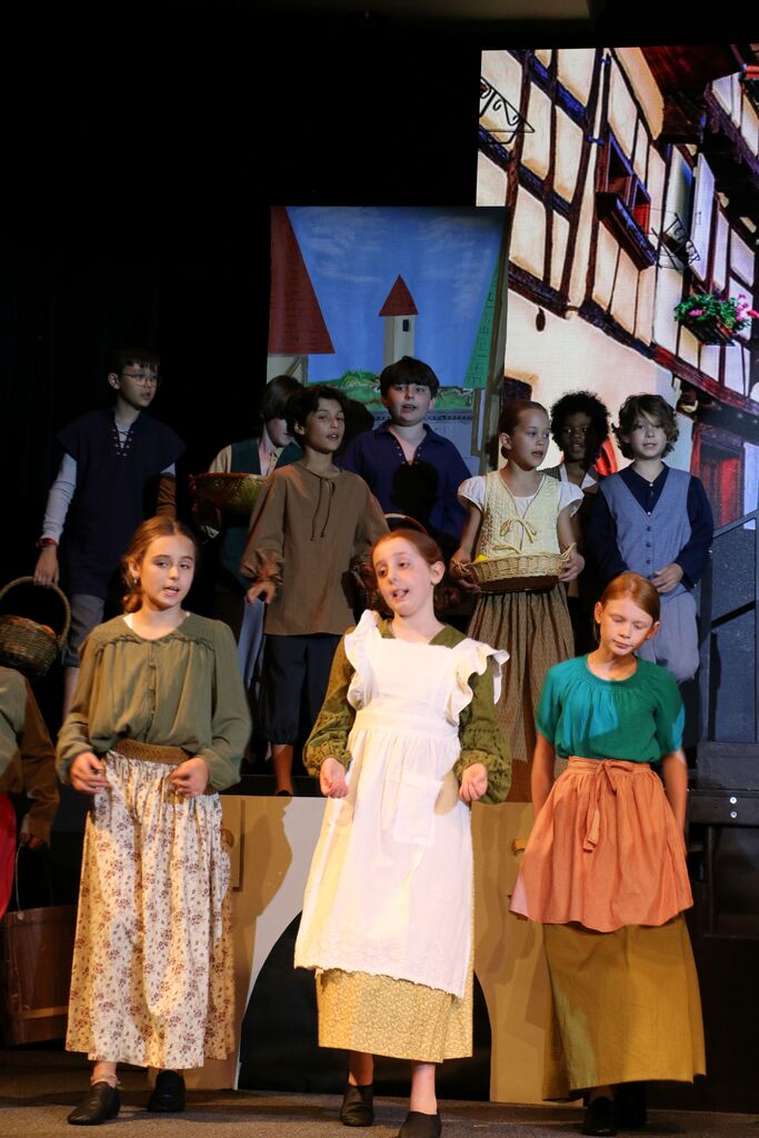 cast during a group number.